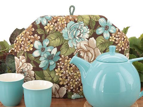 Floral print tea cozies featuring mini, all-over floral prints, chintz style, and all over bouquets of a variety of flowers.